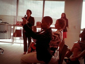 Leticia Barr (standing), Jazzy Jones (with camera) and Xina Eiland (seated) at BlogaTech 2013