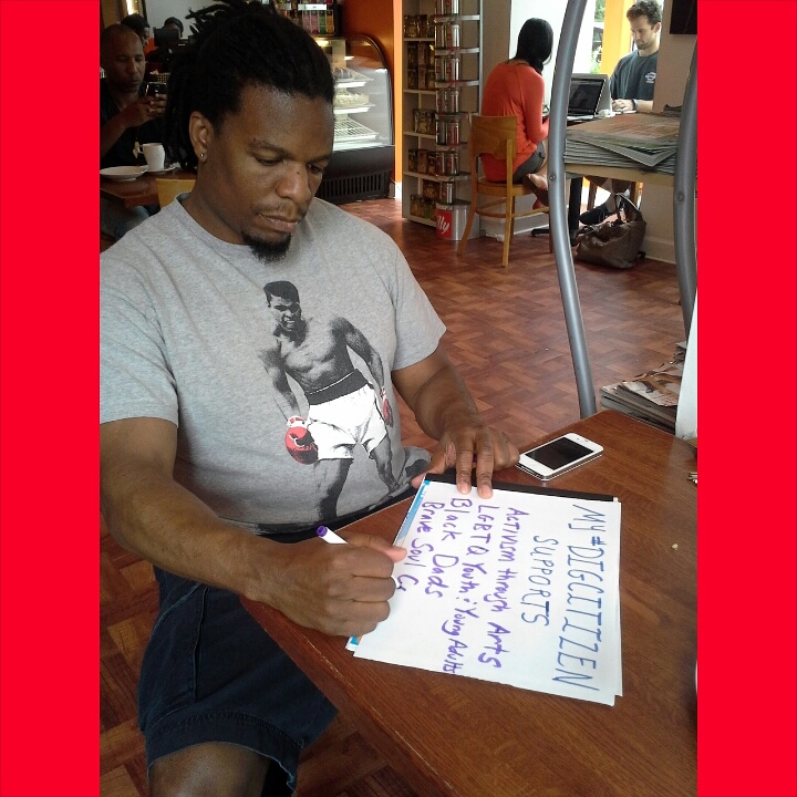 Tim'm West making his My #DigCitizen Supports sign at Azi's Café in DC